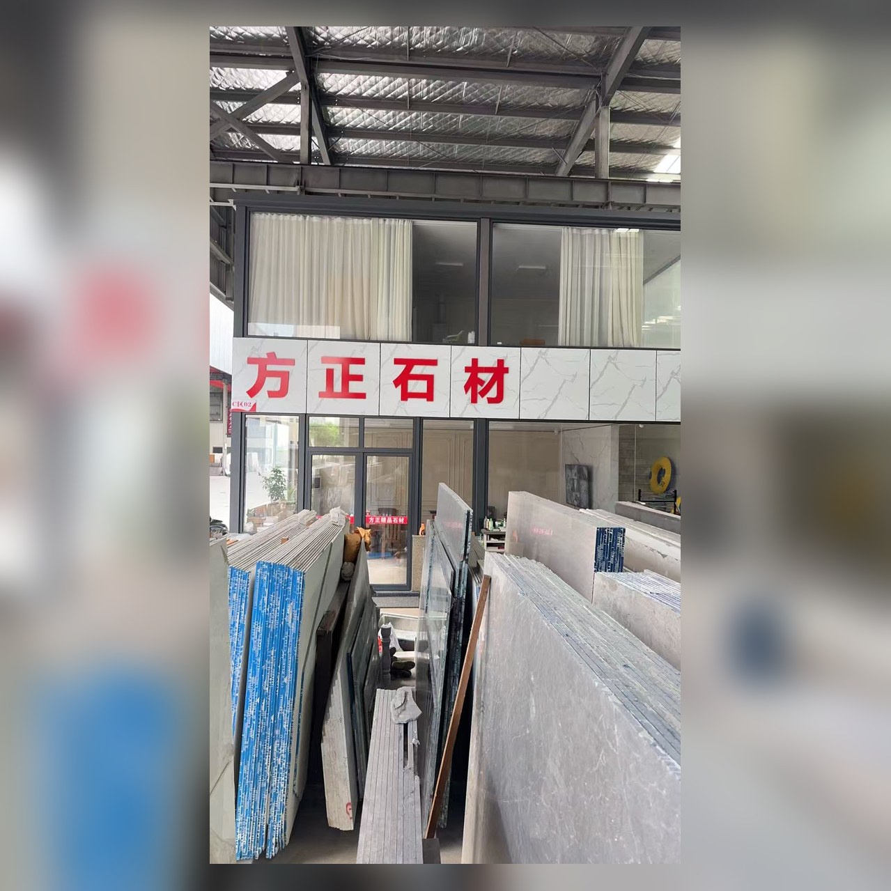 方正精品石材门店门头：越城区东湖街道中亚工贸园石材区C-02，方正石材红色招牌与大板展区